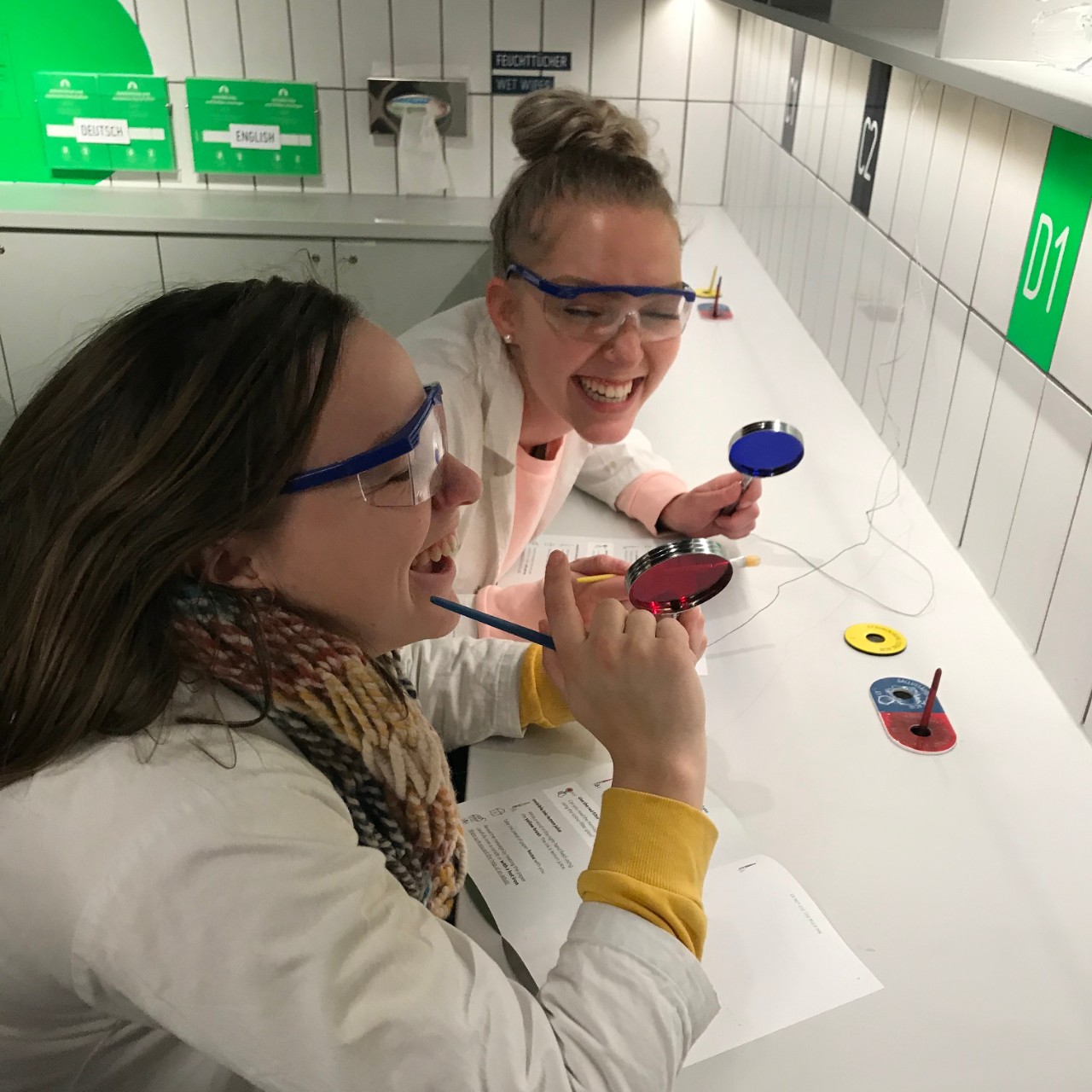 International co-op student Bianca laughs with a coworker in a laboratory.